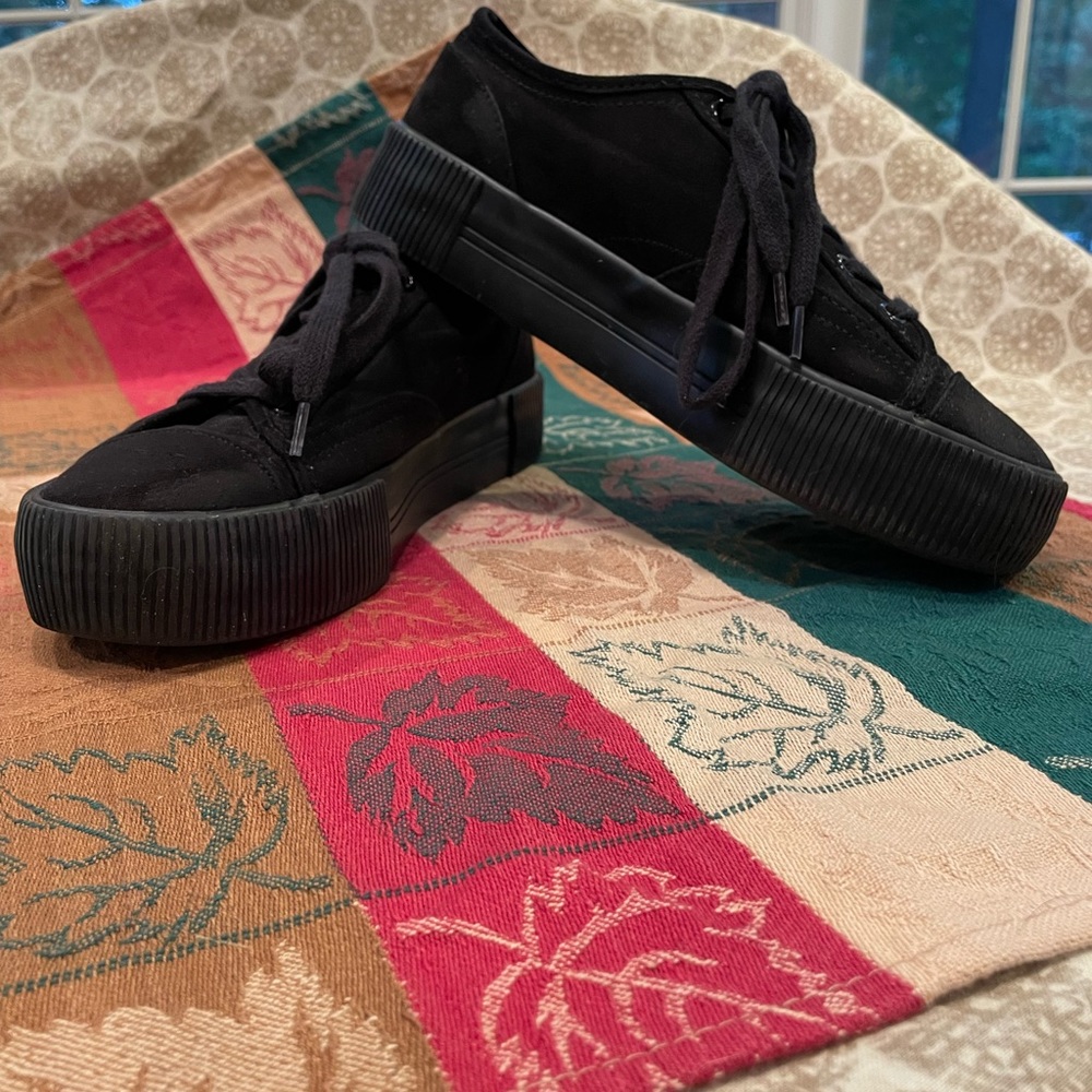Black sueded platform sneakers.